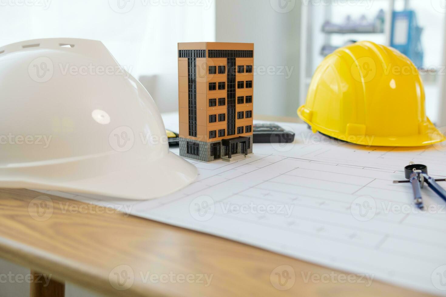 Building models and blueprints are placed on work desks in the construction engineering team offices to plan construction to achieve their goals and to simulate building models for clients to see. photo