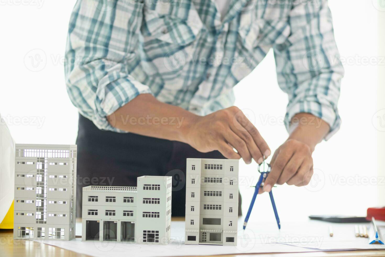 Building models and blueprints are placed on work desks in the construction engineering team offices to plan construction to achieve their goals and to simulate building models for clients to see. photo