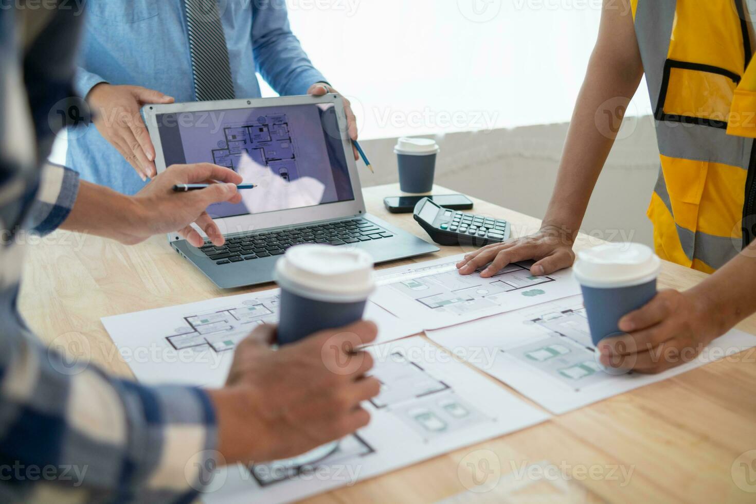 Construction engineers discuss and exchange ideas with architects to improve house plans to meet customer needs. A concept for exchange of design ideas between construction engineers and architects. photo