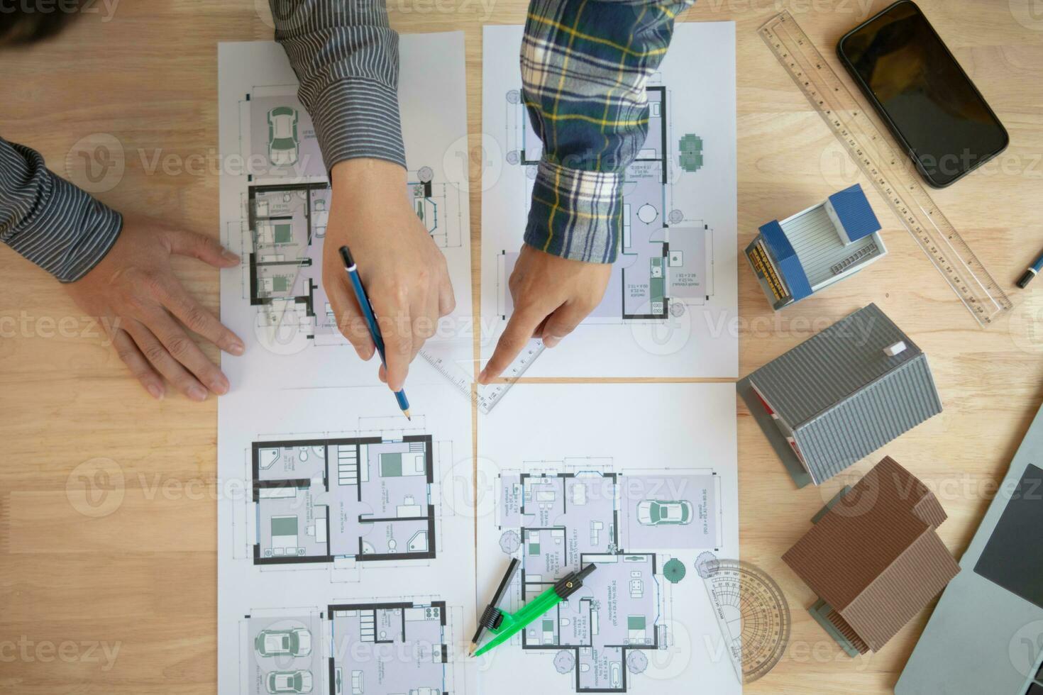 Construction engineers discuss and exchange ideas with architects to improve house plans to meet customer needs. A concept for exchange of design ideas between construction engineers and architects. photo