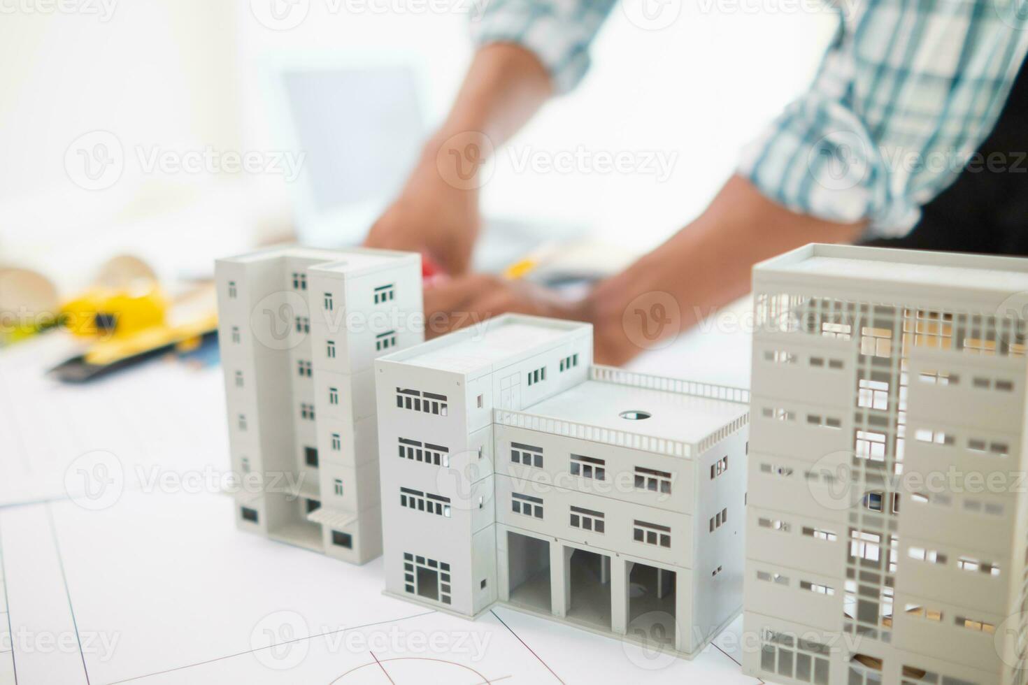 Building models and blueprints are placed on work desks in the construction engineering team offices to plan construction to achieve their goals and to simulate building models for clients to see. photo