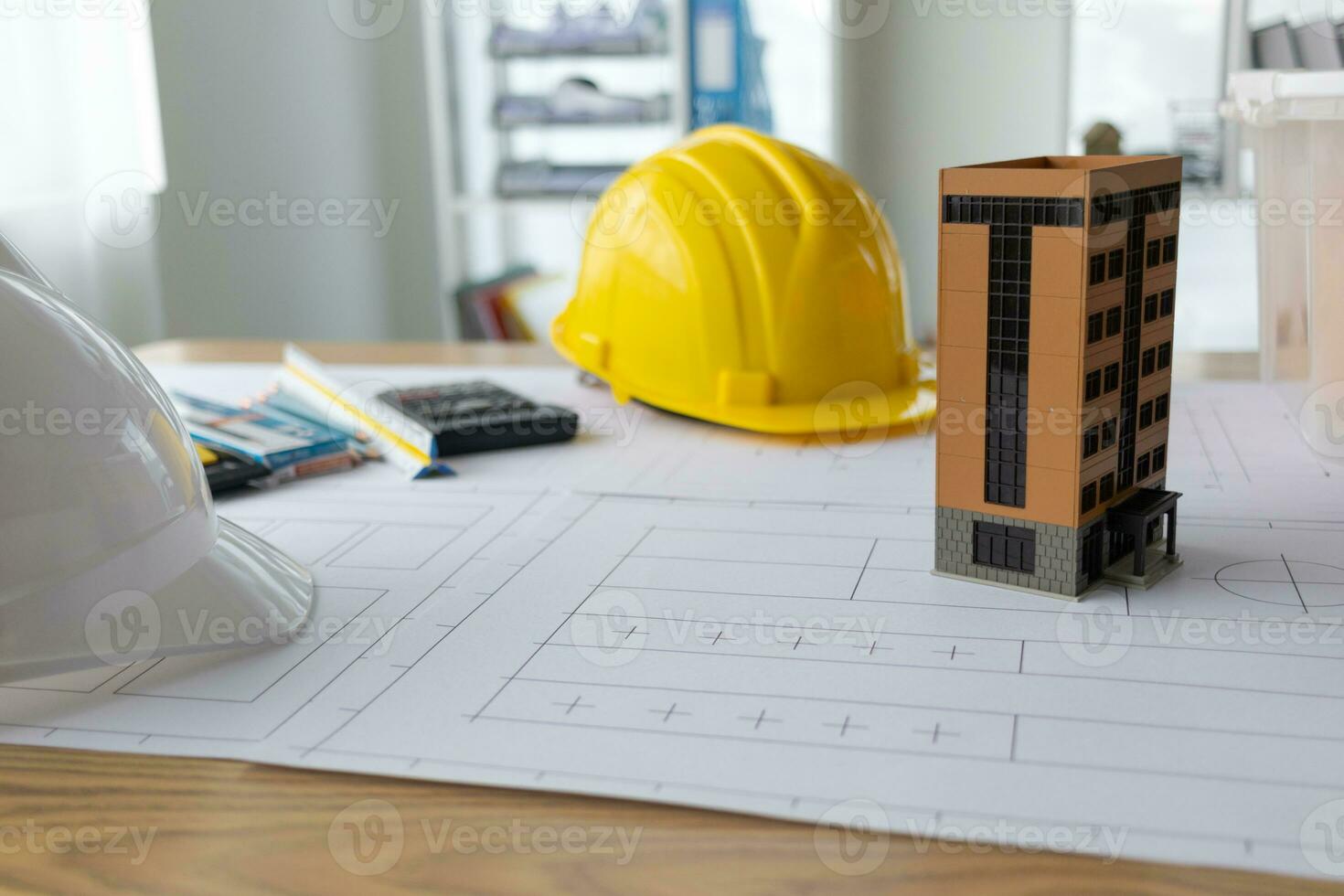 Building models and blueprints are placed on work desks in the construction engineering team offices to plan construction to achieve their goals and to simulate building models for clients to see. photo