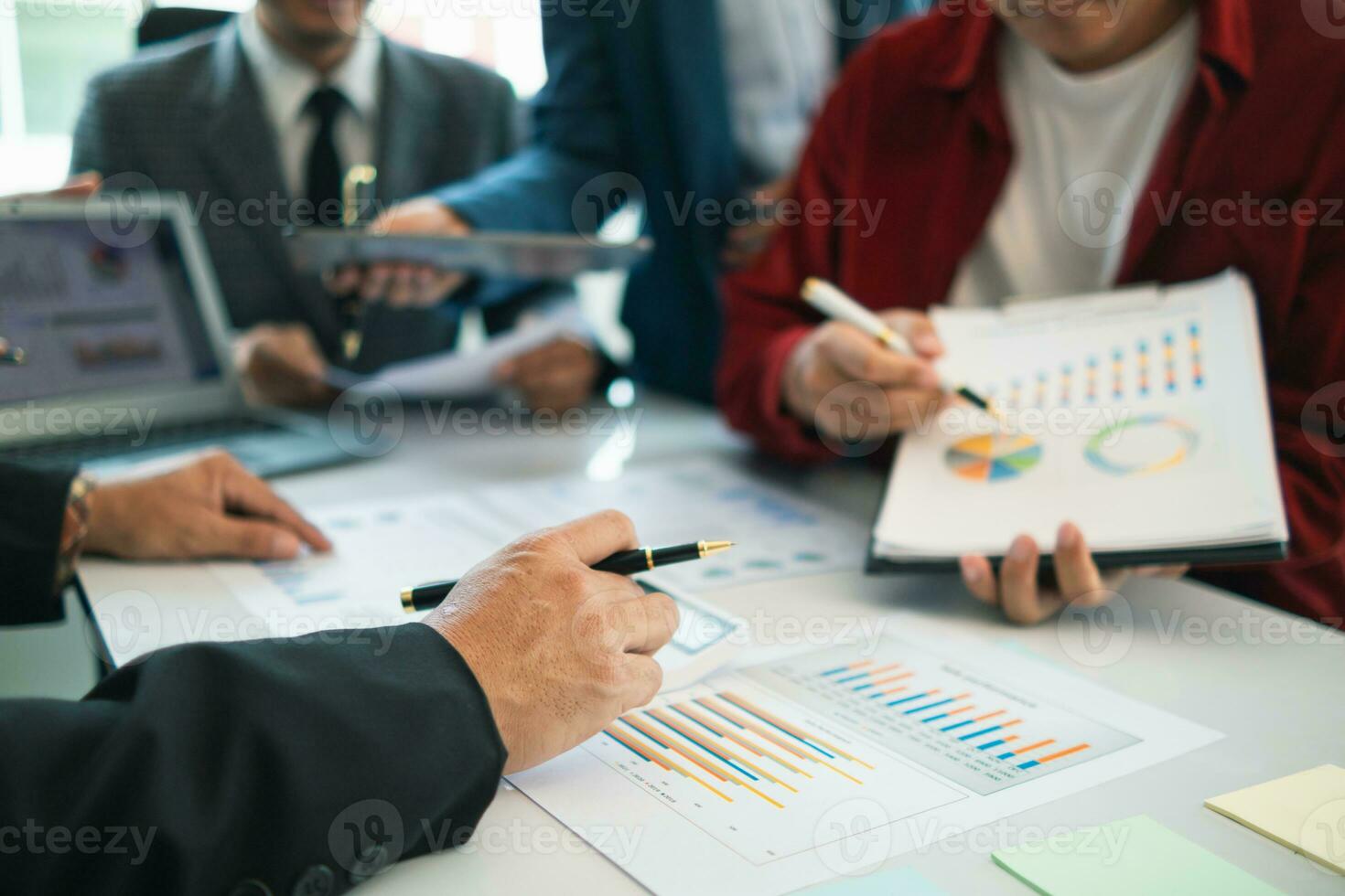 group businessmen and investors met together in conference room to view annual results their investments in business together in order to plan marketing doing business that would produce better result photo