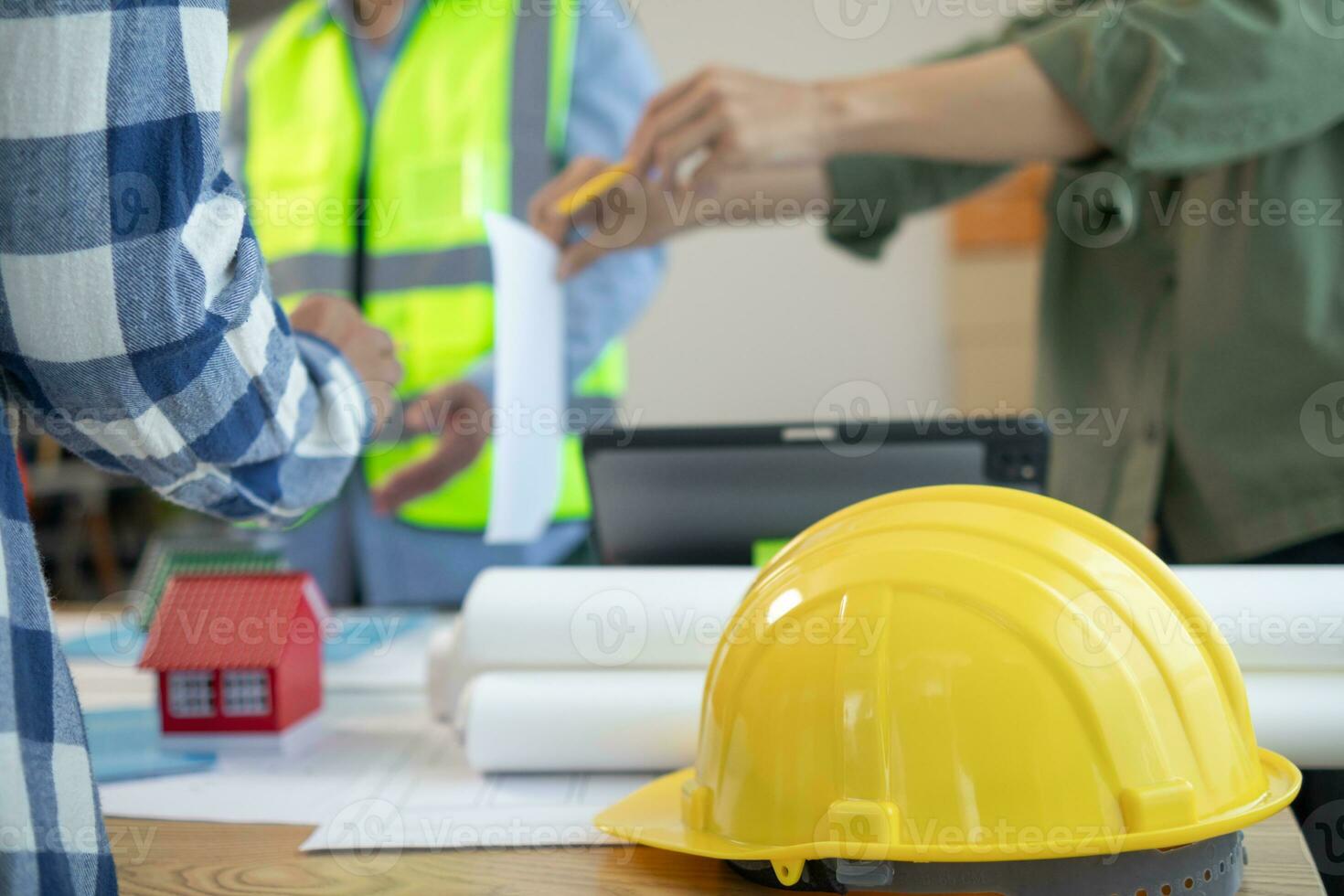 Yellow safety helmet were prepared for workers to wear before entering the construction area to prevent the danger of falling objects from working. Yellow safety helmet is placed on a wooden table. photo
