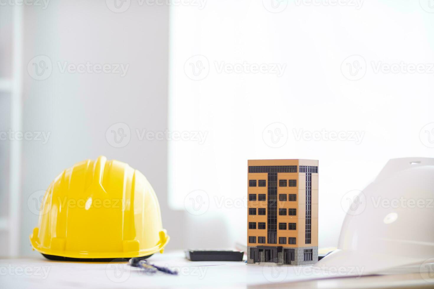 Yellow safety helmet were prepared for workers to wear before entering the construction area to prevent the danger of falling objects from working. Yellow safety helmet is placed on a wooden table. photo