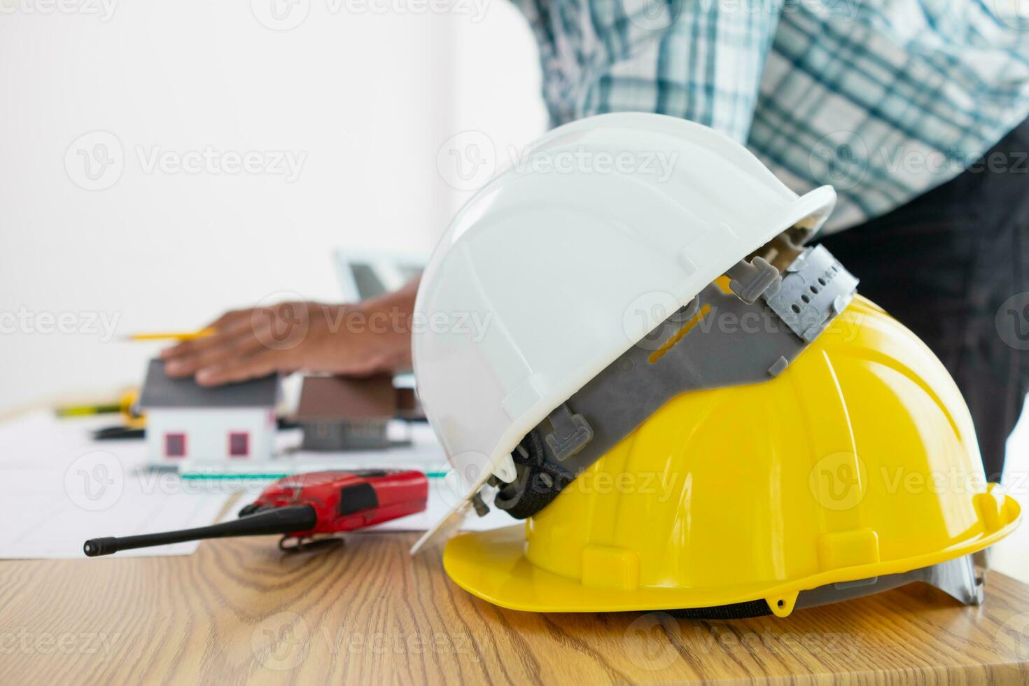 Yellow safety helmet were prepared for workers to wear before entering the construction area to prevent the danger of falling objects from working. Yellow safety helmet is placed on a wooden table. photo
