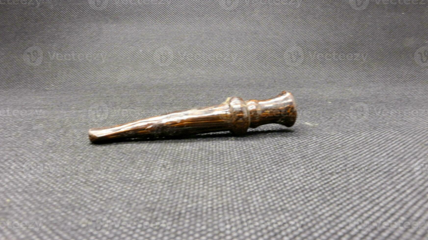 Indonesian wooden pipe for smoking photo