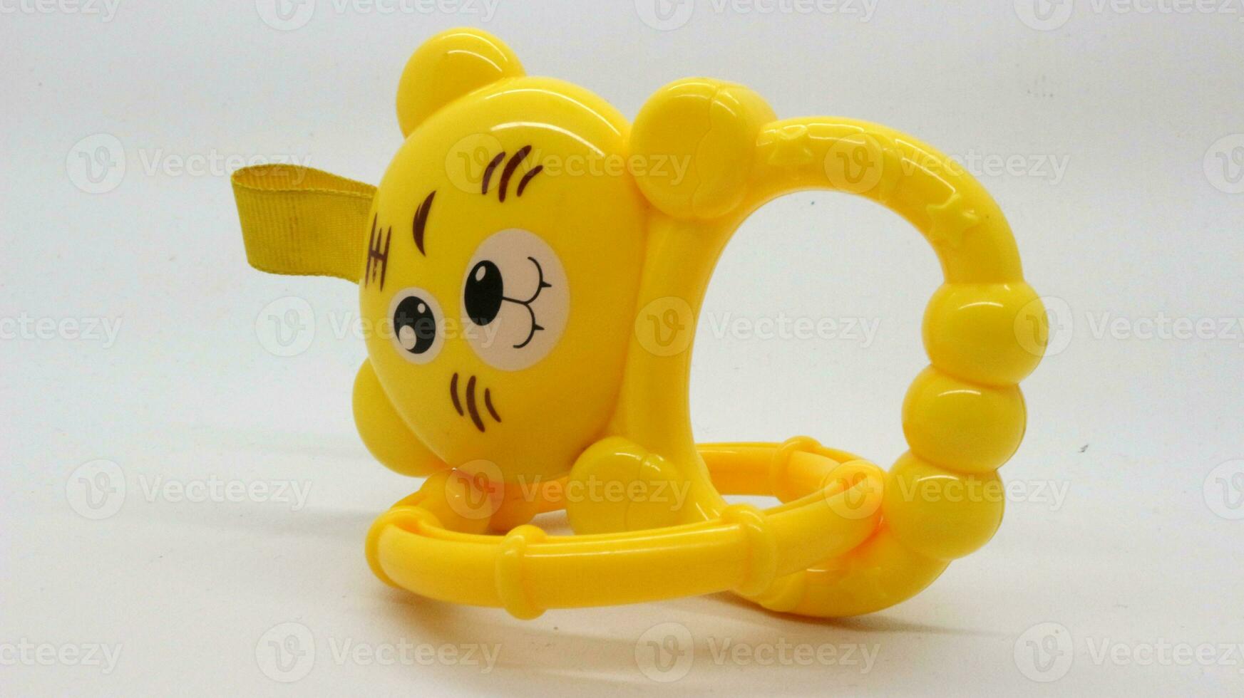 Yellow baby holding toy with bear shape isolated photo