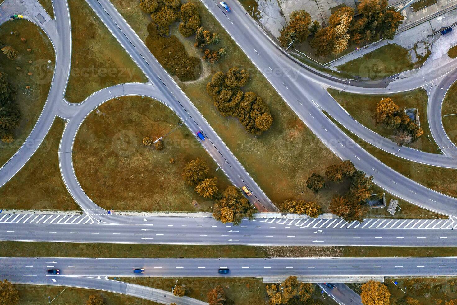 Aerial top view of the modern highway road intersection in autumn. Drone photography. photo