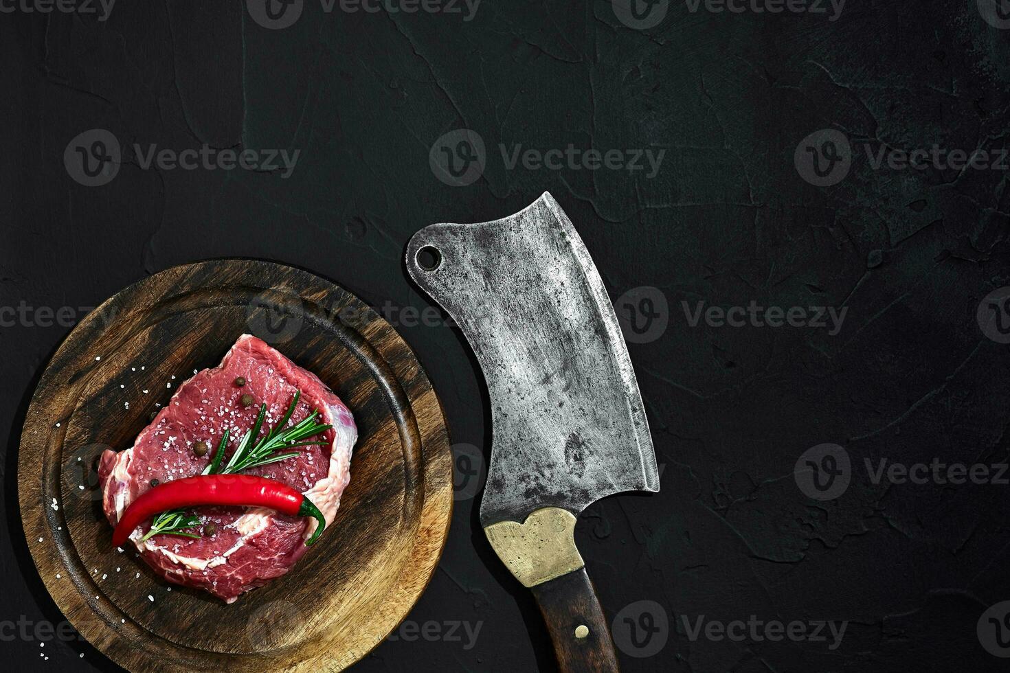 Raw beef steak dry aging on wooden cutting board. Copy space photo