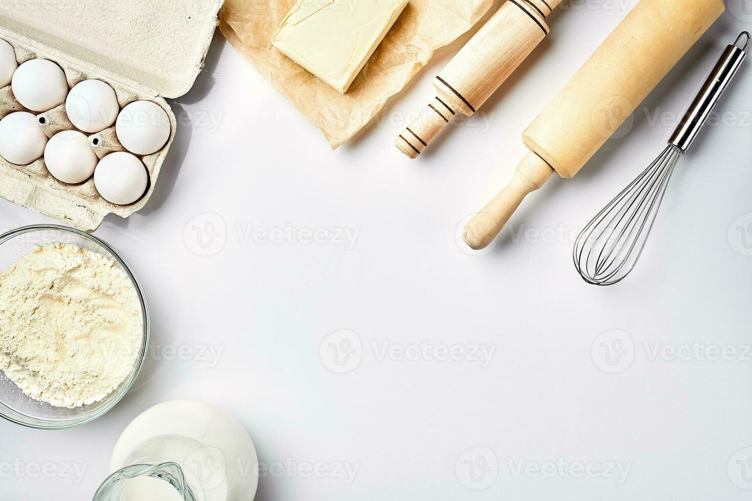 Preparation of the dough. A measurement of the amount of ingredients in the recipe. Ingredients for the dough flour, eggs, rolling pin, whisk, milk, butter, cream. Top view, space for text photo