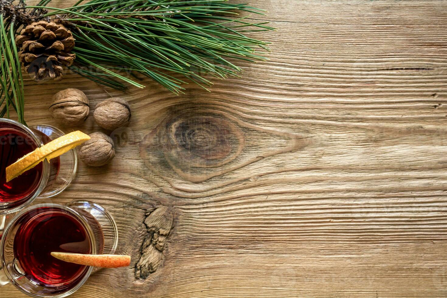 Mulled wine with spices on wooden background photo