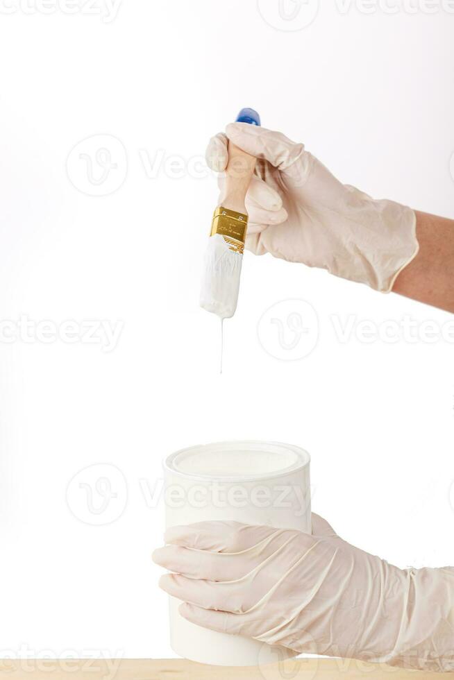 white paint with a brush painting a wooden background with texture photo