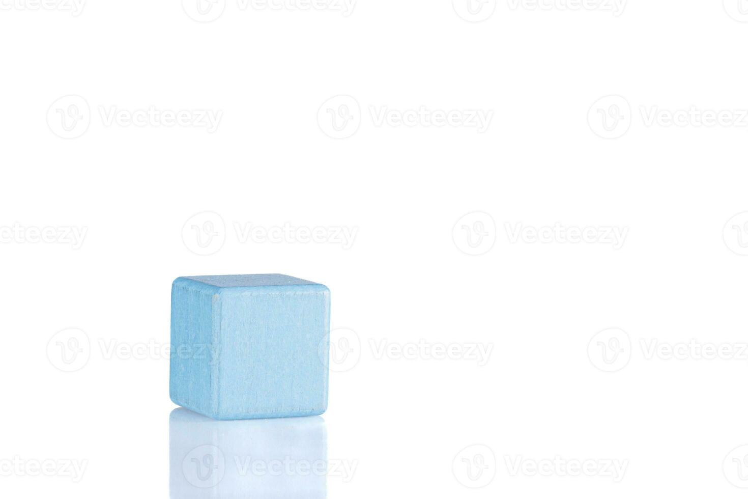 Wooden cube of blue color on a white background photo