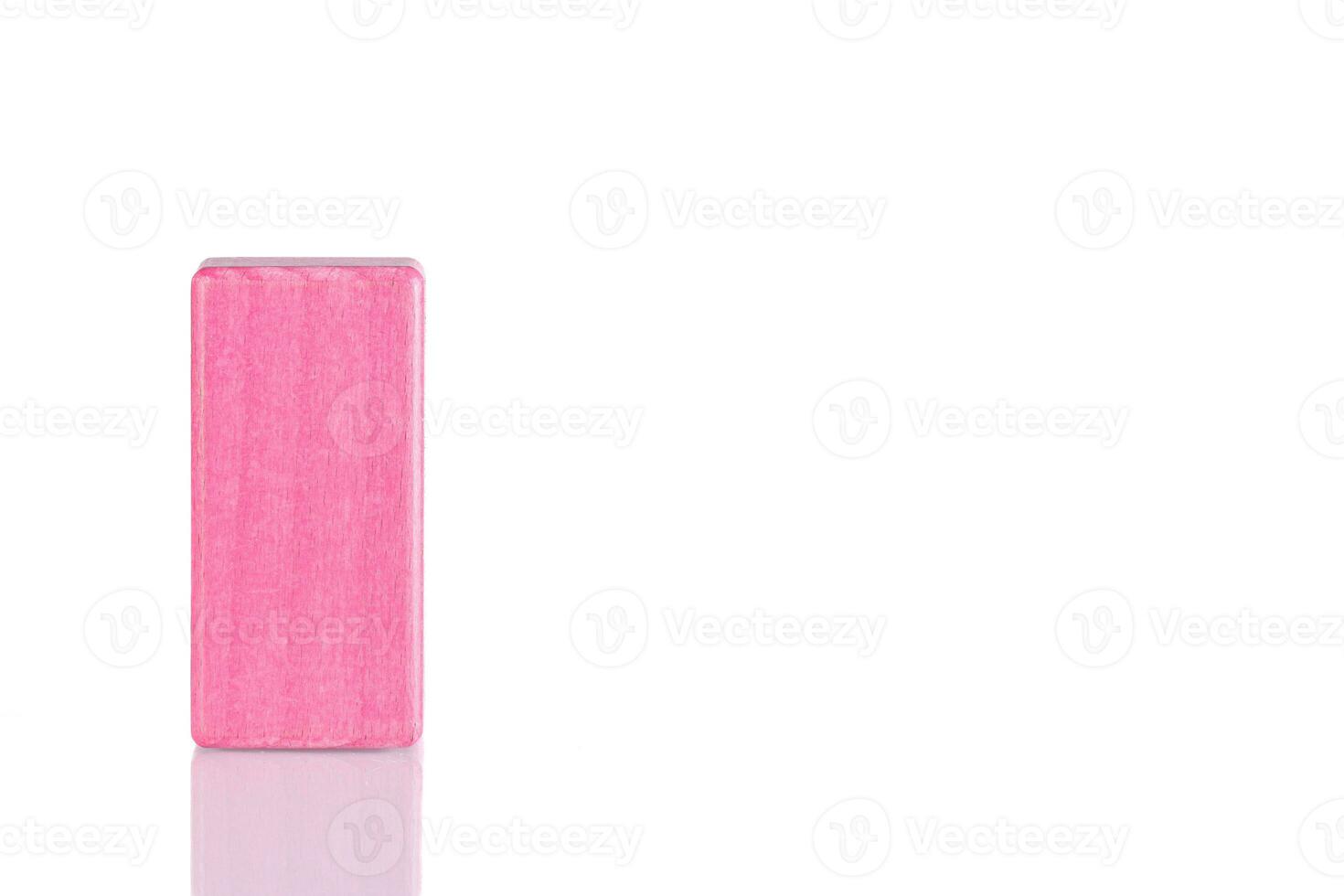 Wooden cube of pink color on a white background photo