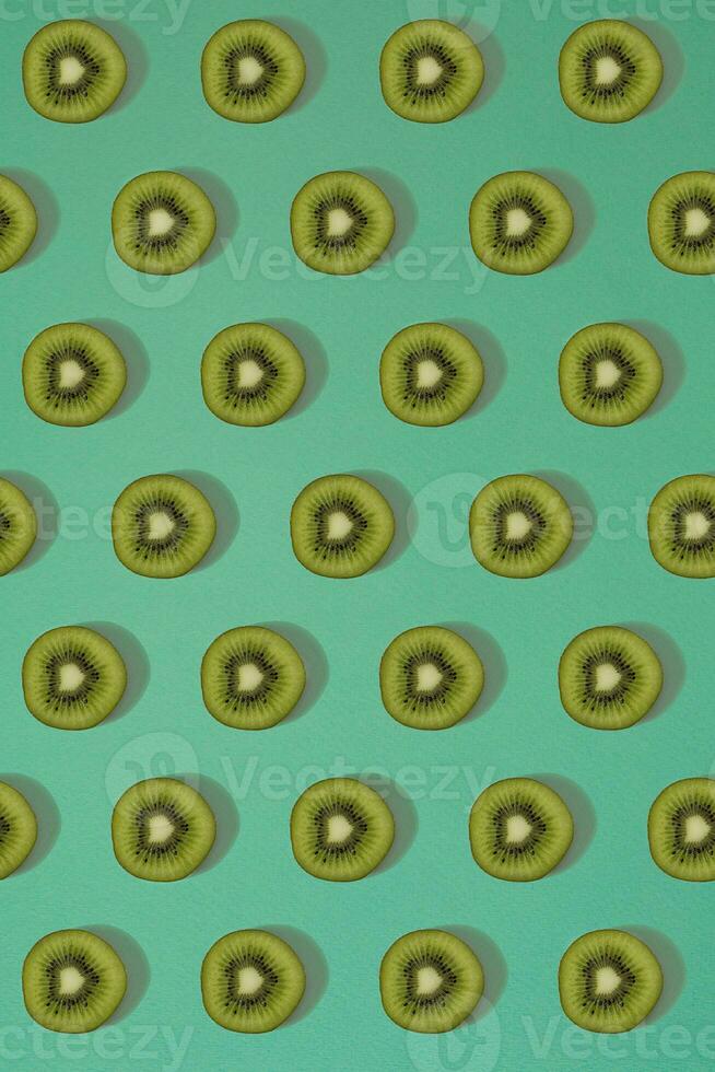 Pattern of kiwi. Top view of the sliced kiwi on blue background. Minimal flat lay concept. photo