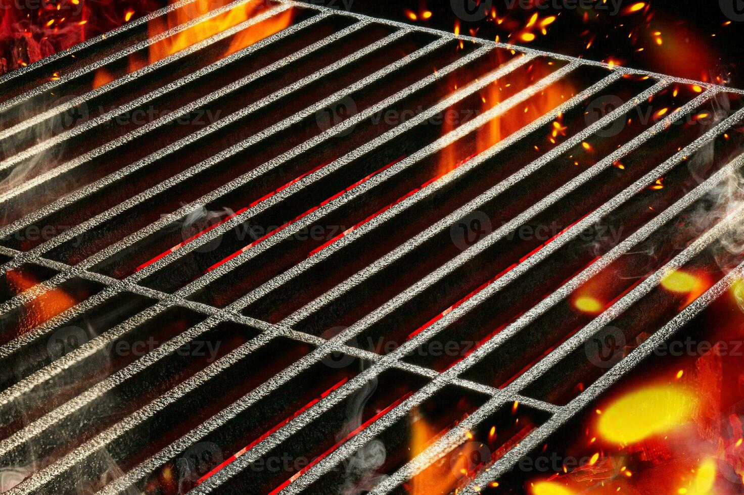 Hot empty portable summer barbecue BBQ grill with bright flaming fire and ember charcoal. Cookout concept. Close up photo