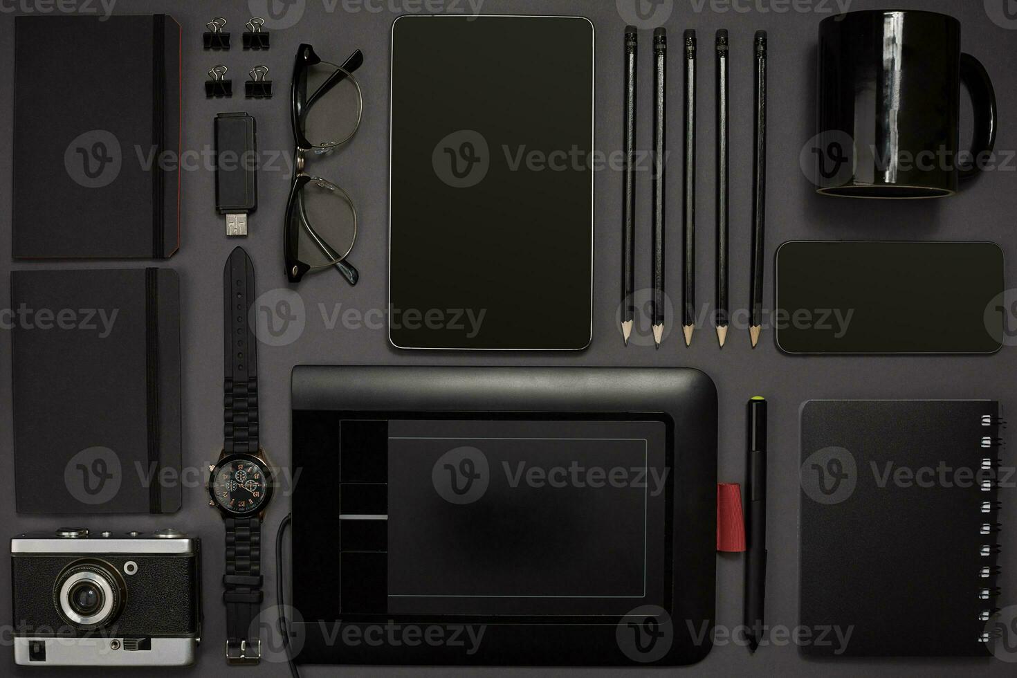 Black objects from the office on a dark gray background. Work an photo