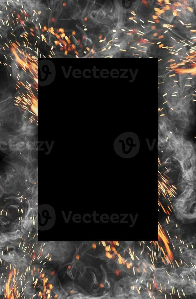 Frame made of smoke and hot sparks against black background. Close up, copy space for your design, text or images photo