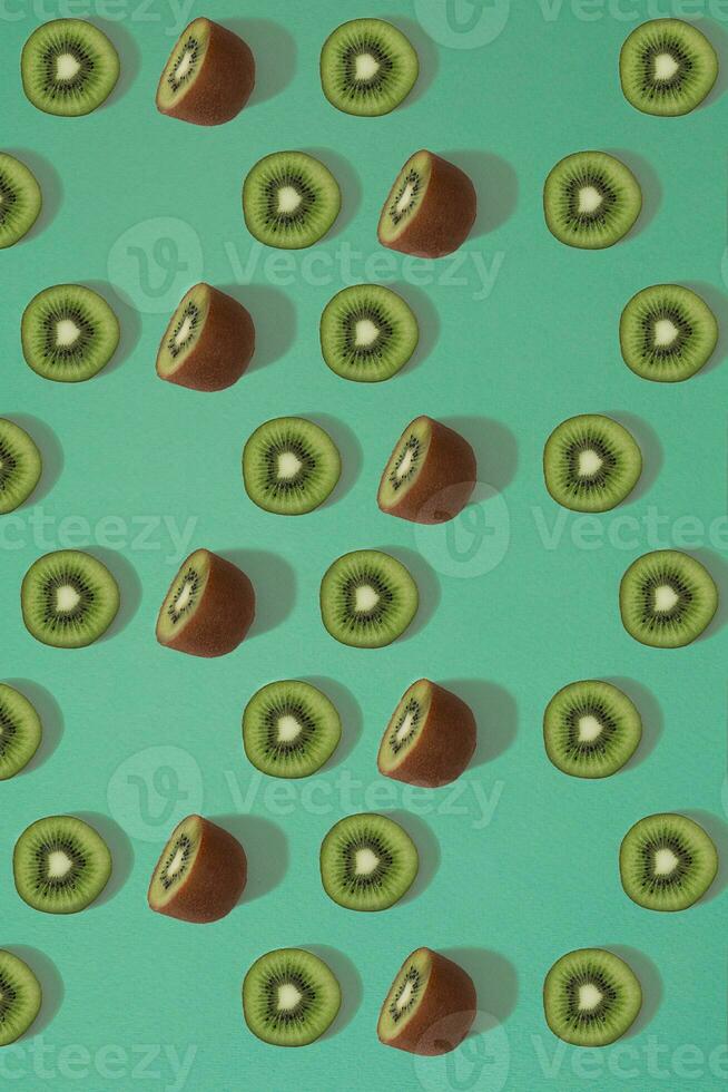 Pattern of kiwi. Top view of the sliced kiwi on blue background. Minimal flat lay concept. photo