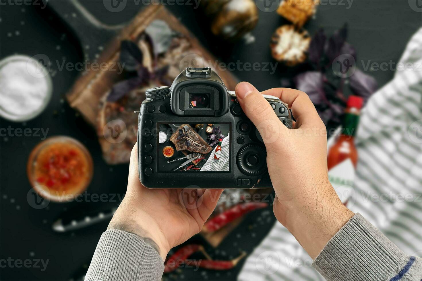 Digital single-lens reflex camera in hands. Man photographer makes photos. Male hands hold the camera close-up photo