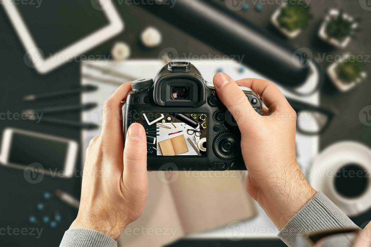 Digital single-lens reflex camera in hands. Man photographer makes photos. Male hands hold the camera close-up photo