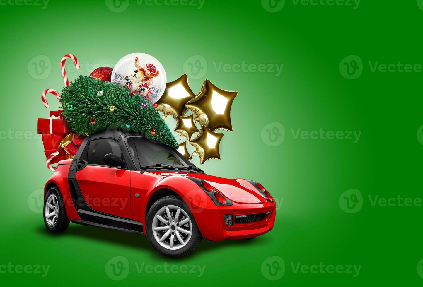 Red car on green background. Christmas tree, presents, balloons in form of golden stars, snow globe, candies on roof. Collage. Copy space, close-up. photo
