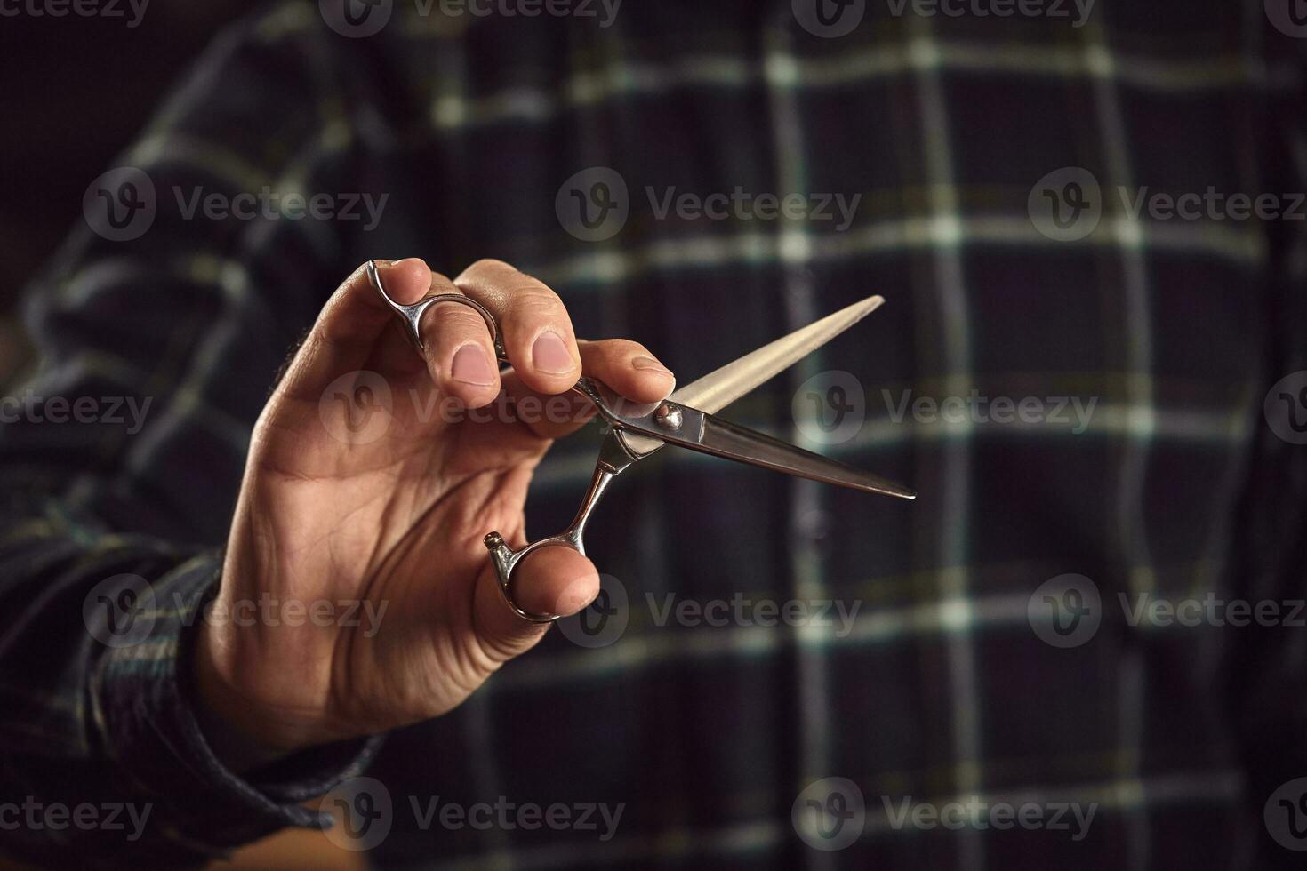 Barber is holding scissors in his hands barbershop. photo
