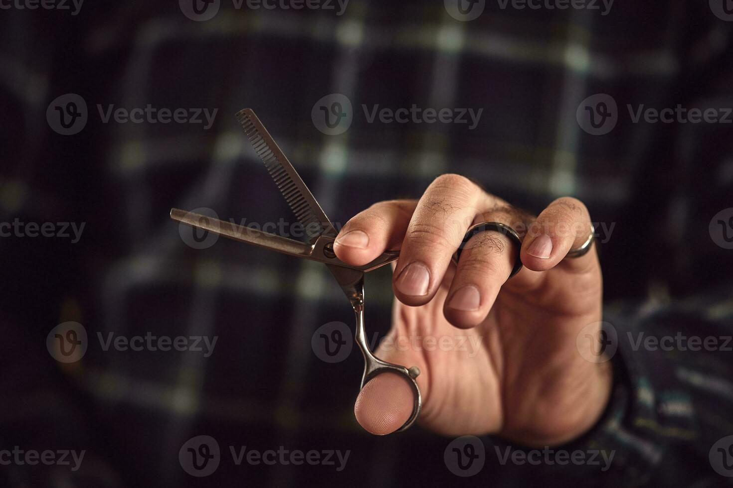 Barber is holding scissors in his hands barbershop. photo