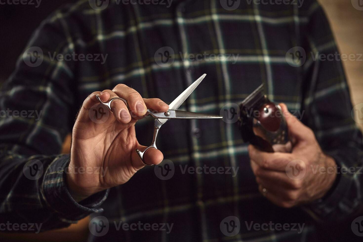 Barber is holding scissors and razor in his hands barbershop. photo