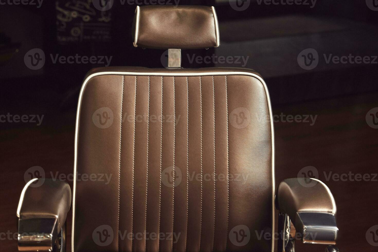 Brown leather chair in barbershop. Loft style photo