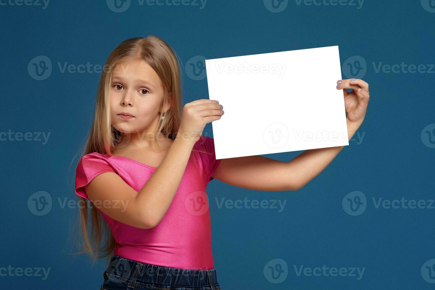 Portrait of adorable emotional little girl on blue background photo