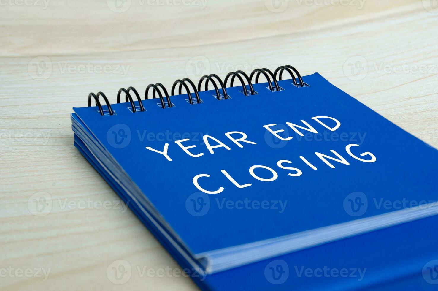 Year end closing text on blue notepad. Year end closing concept photo