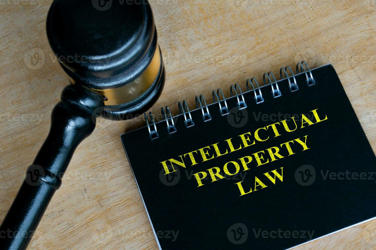 Top view of black notebook with text Intellectual Property Law and with gavel background photo