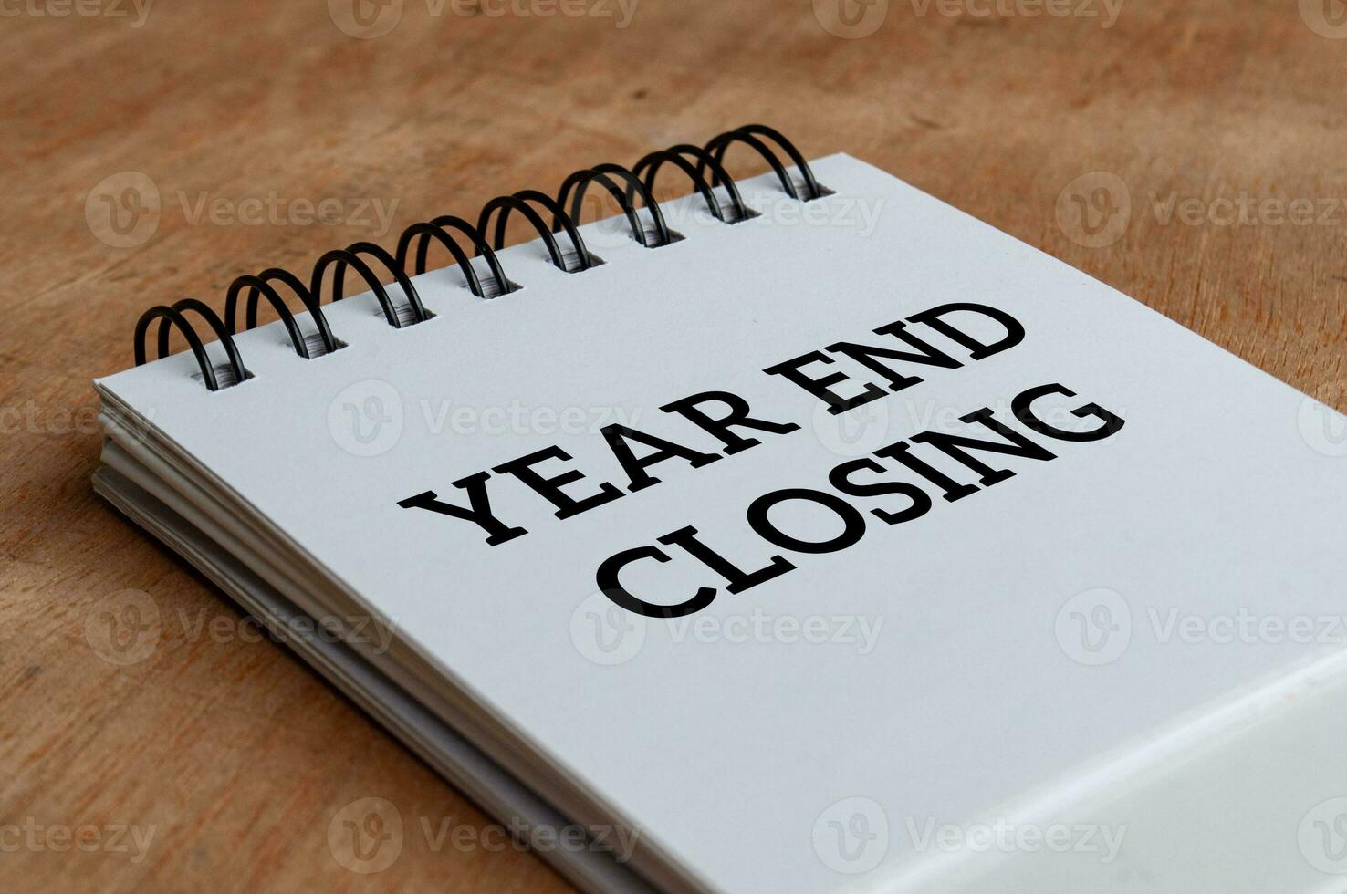 Year end closing text on white notepad. Year end closing concept photo