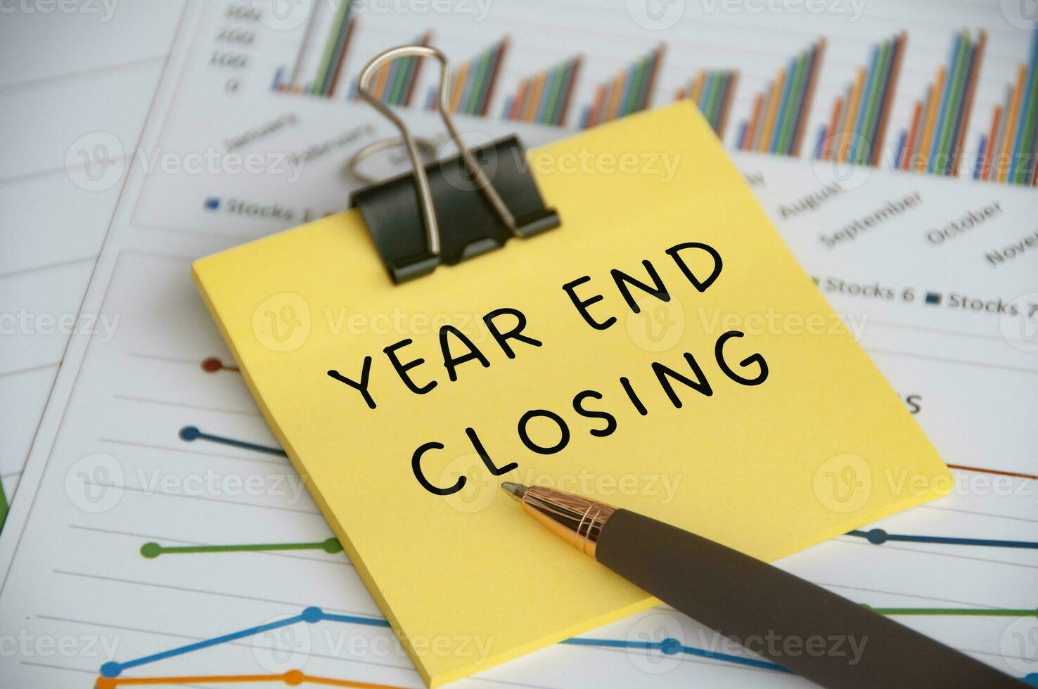 Year End Closing text on sticky note with statistic and graph background. Closing concept. photo