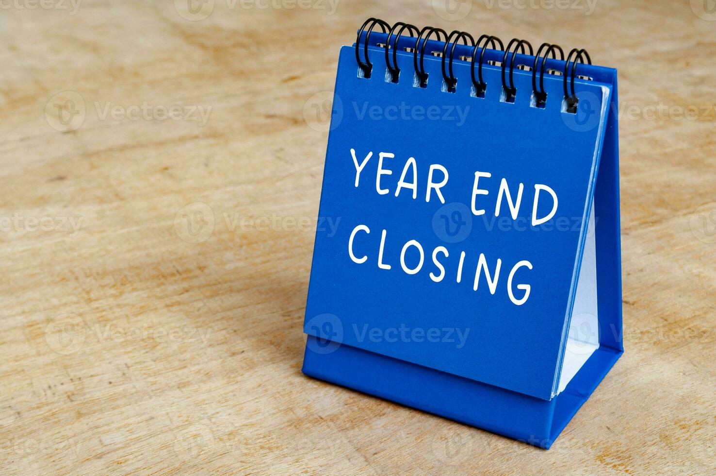 Year end closing text on blue notepad with customizable space for text. Closing concept. photo