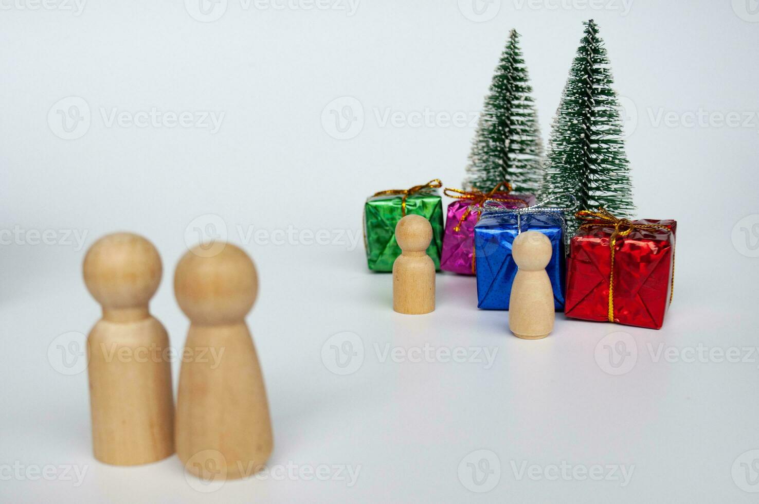 Father and mother giving out presents to their children during Christmas celebration photo