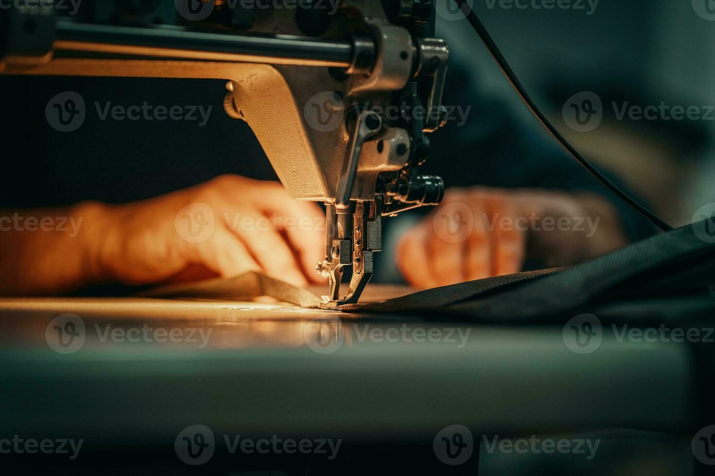 Sewing machine and men's hands of a tailor photo