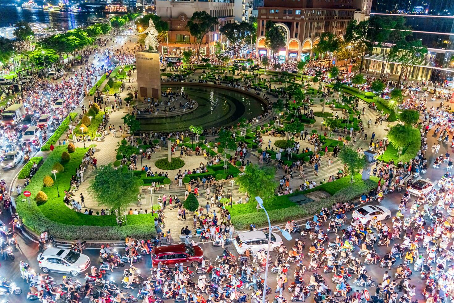 Ho Chi Minh city, Vietnam - Sep 2, 2023 View of Me Linh roundabout with heavy traffic near Bach Dang waterbus station port and Saigon river at blue hour photo