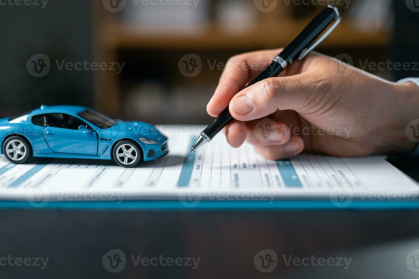 Woman signing car insurance document or lease paper. Writing signature on contract or agreement. Buying or selling new or used vehicle. Car keys on table. Warranty or guarantee. Customer or salesman. photo