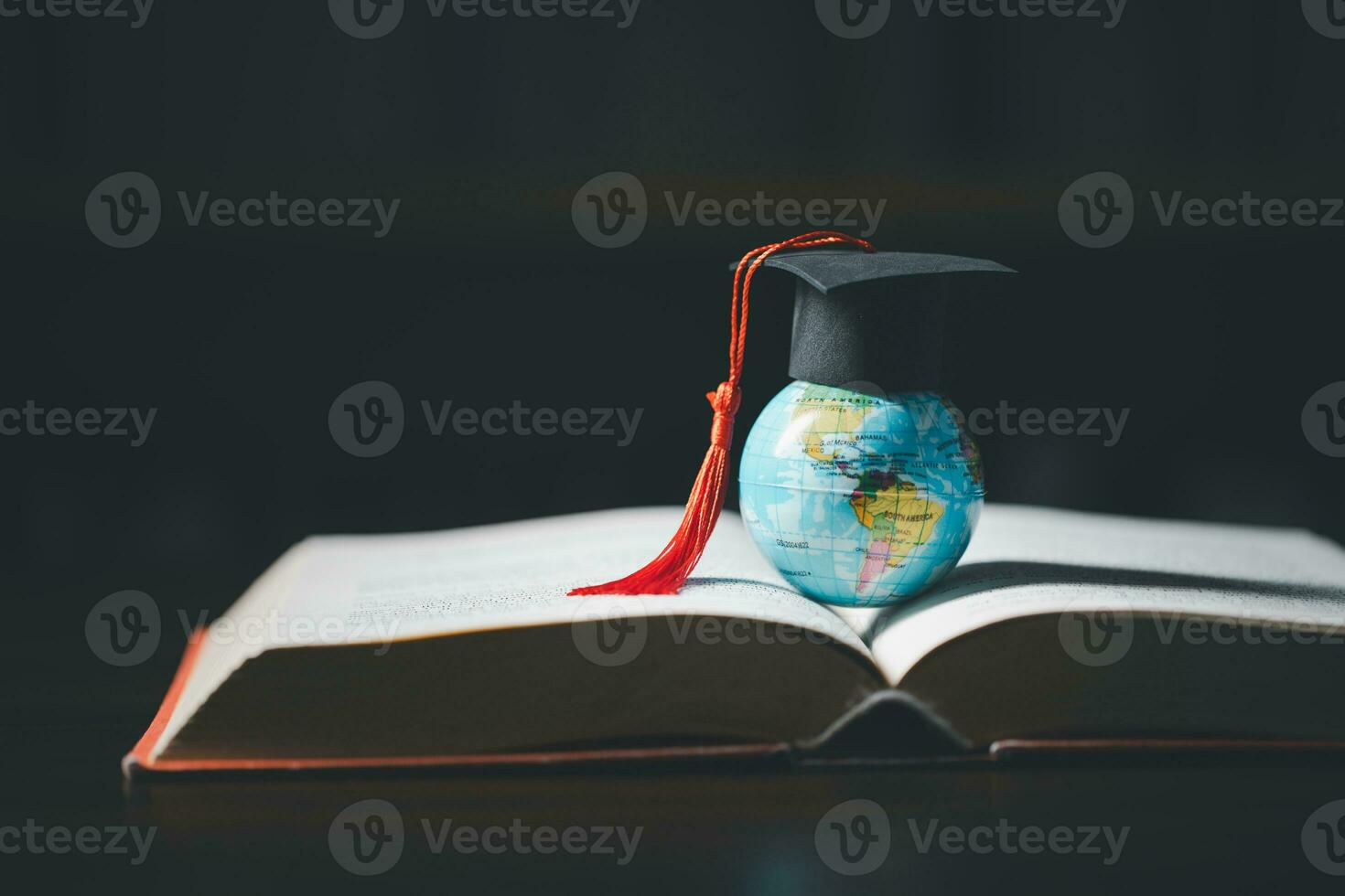 Graduated study abroad international Conceptual, Graduation hat on top Earth globe model map.Congratulations to graduates, Studies lead to success in world wide.Back to School. credited world by NASA photo