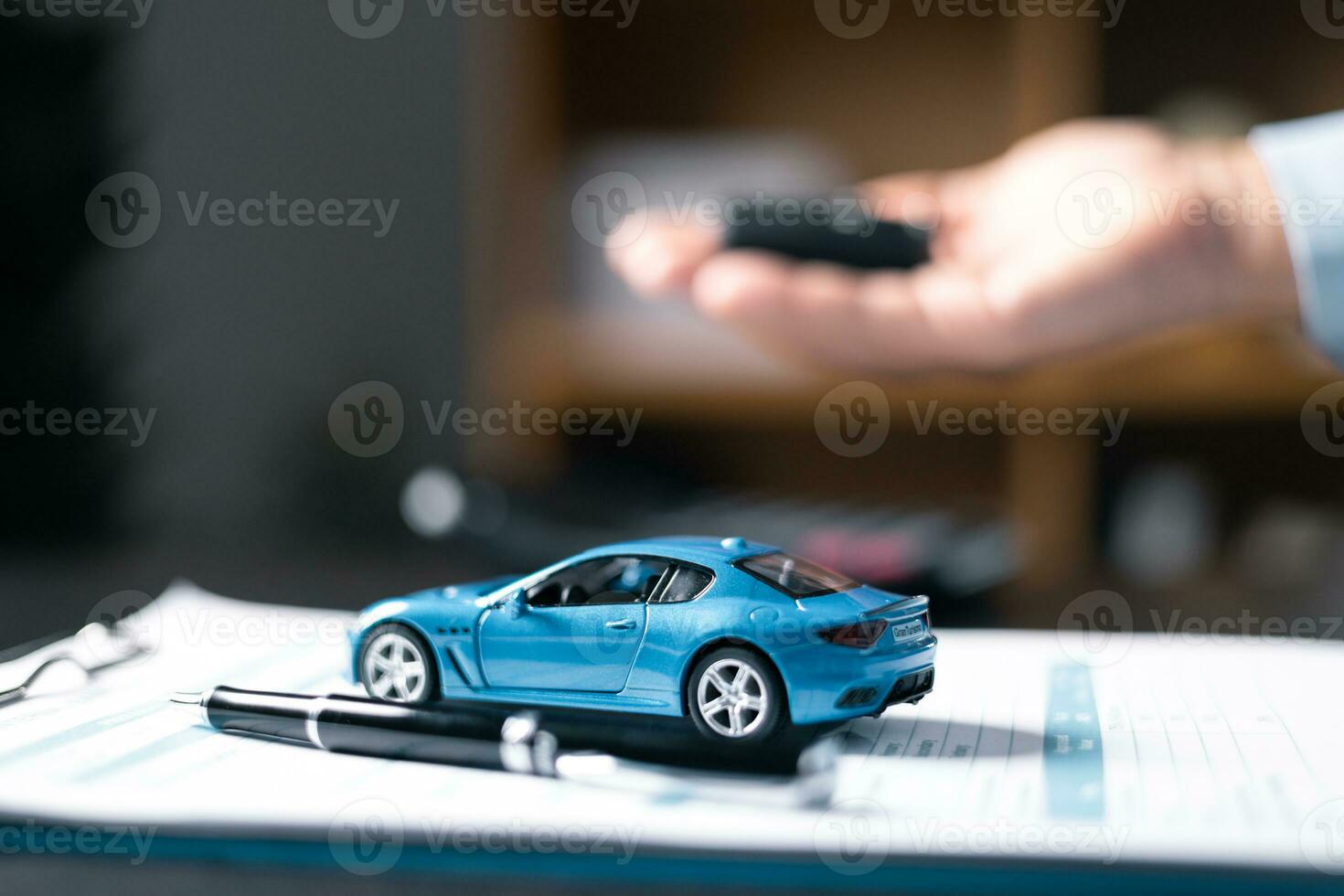 Car dealers or insurance managers cover and protect against damage and the risk of driving, Hold the car keys, Protecting and after-sales care concept. offering financial and insurance service. photo
