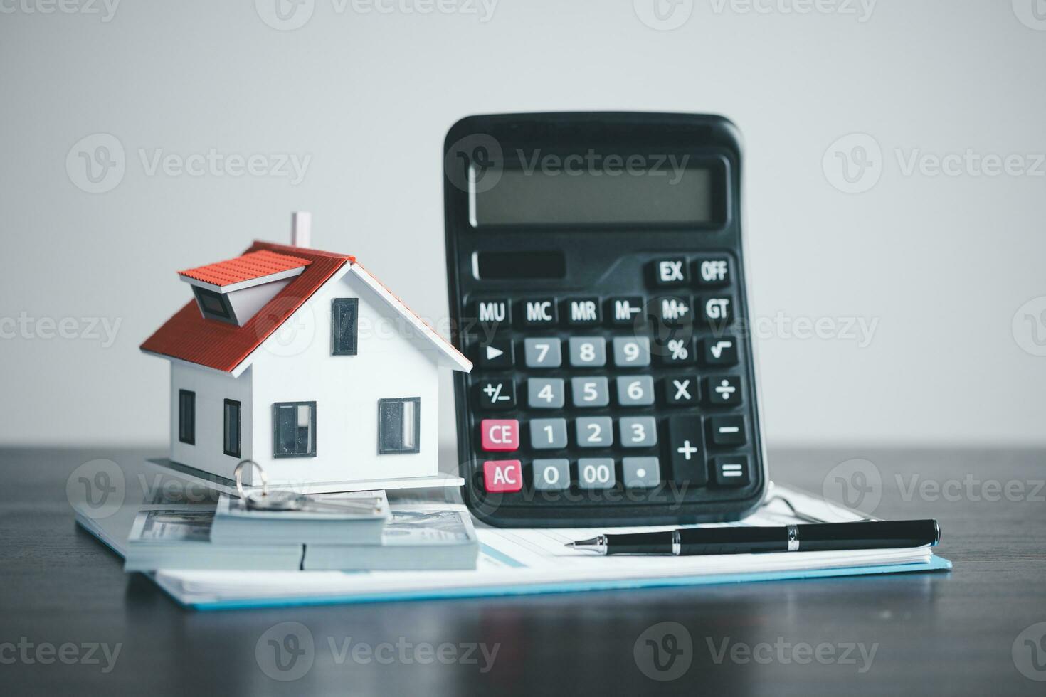 model home on wooden table, Save money concept, Property investment, house loan, reverse mortgage, gold coins money stack growth, saving money coins stack future for home photo