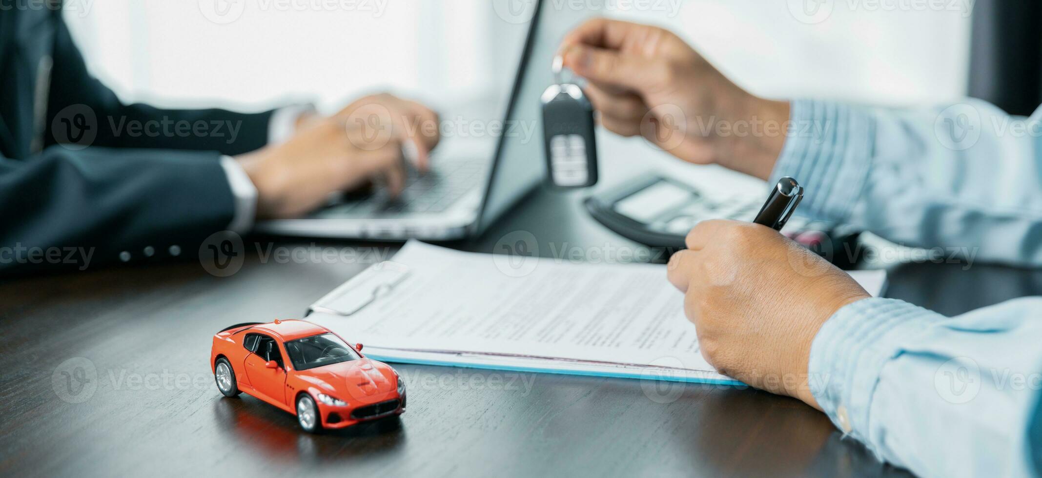 Car dealers or insurance managers cover and protect against damage and risk of driving,Hold car keys,Protecting and after-sales care concept.successful car loan contract buying or selling new vehicle. photo