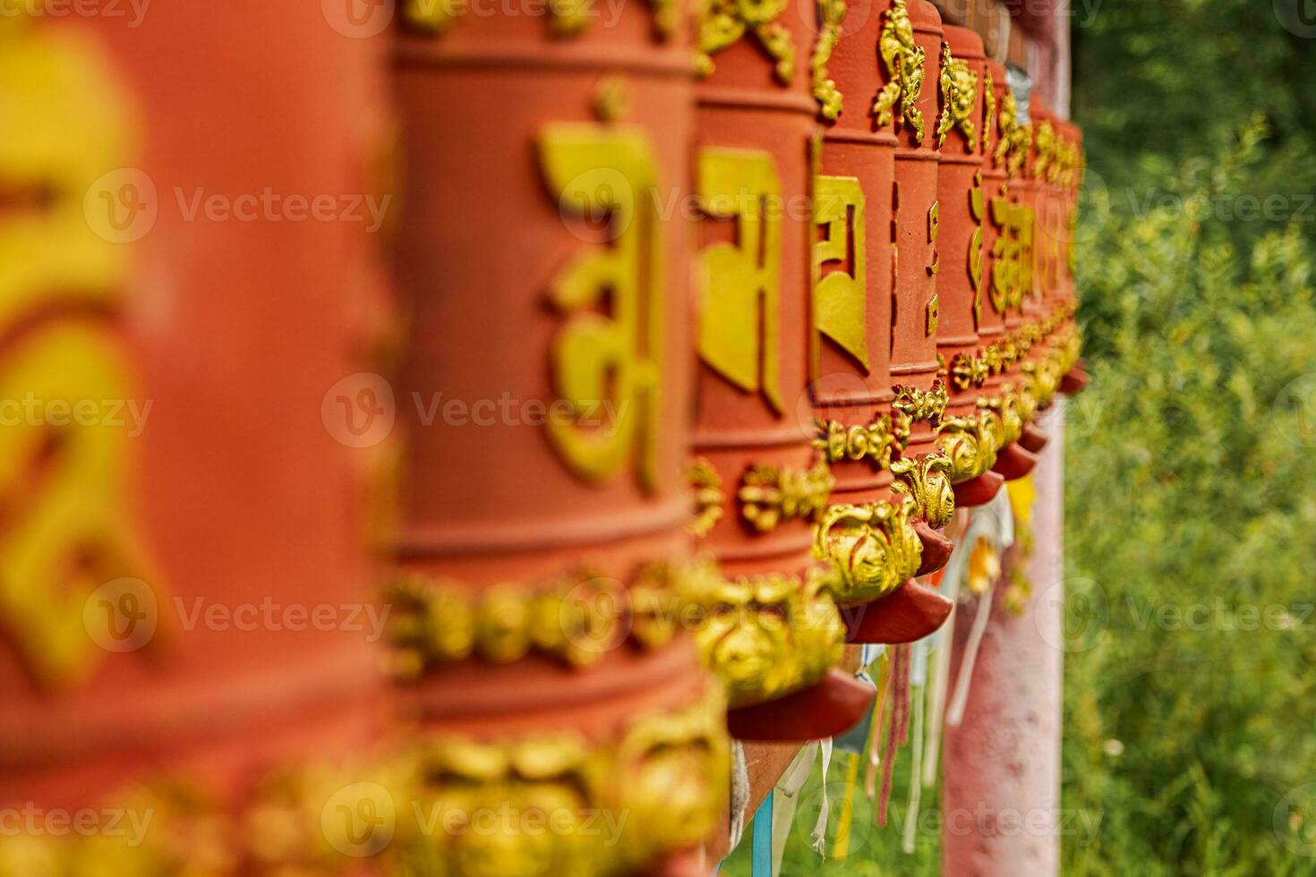 Rotating religious elements for touching turning spinning Buddhist prayer wheel at Buddhist monastery. Prayer wheels in Buddhist stupa temple. Buddhism religion concept. photo
