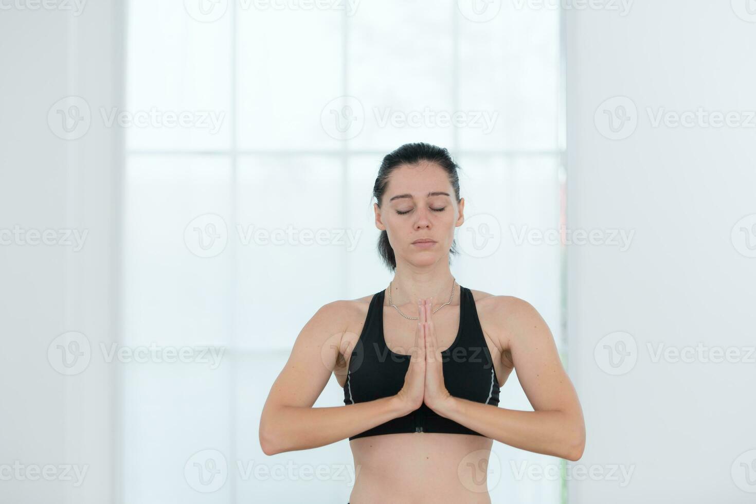 Beautiful young woman practicing yoga at home. Yoga asana. photo