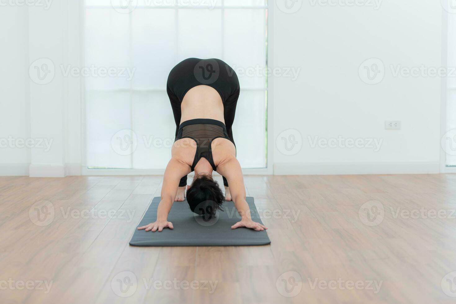 Beautiful young woman practicing yoga at home. Yoga asana. photo