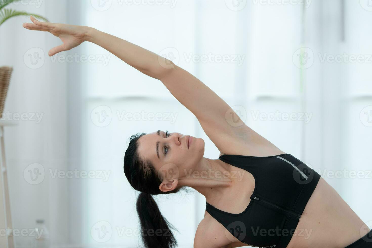 Beautiful young woman practicing yoga at home. Yoga asana. photo