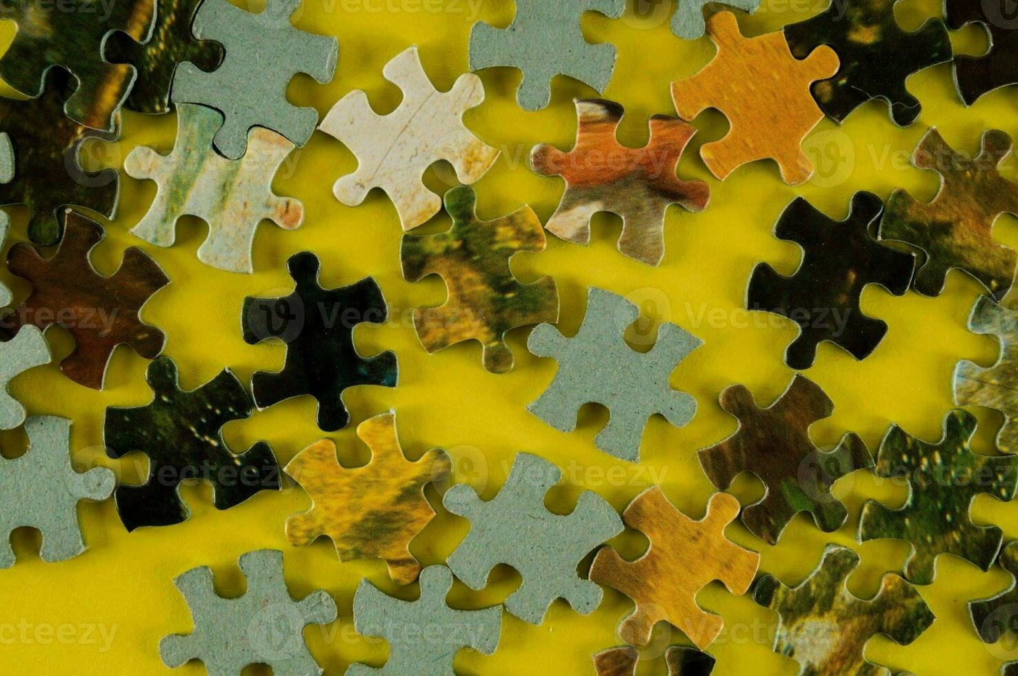 a yellow background with a puzzle piece on it photo